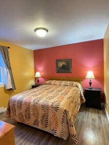 夏洛特顿Fair Isle Motel的一间卧室设有一张床和红色的墙壁
