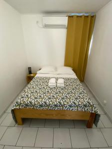 萨莱比梅Appartement moderne, 2 chambres, proche aéroport • CHU • port的小卧室配有带两双鞋的床