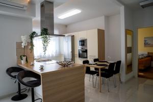 杰尔Sunshine Apartman with Free Parking的厨房以及带桌椅的用餐室。