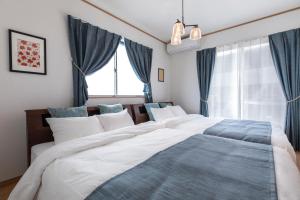恩纳Y's沖縄リゾートベースNo.1的一间卧室设有两张床和窗户。
