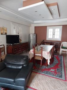 Zāwiyat al Habbābīyahفيلا انور يسن ابو كليلة的客厅配有桌子和沙发