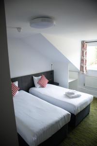 拉格比德雷科特酒店&怀特菲尔德高尔夫球场的带窗户的客房内设有两张单人床。