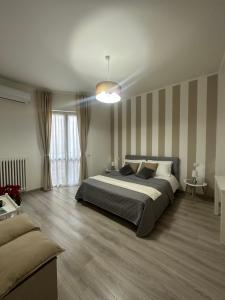 斯特雷萨Fior&Iris Apartments的一间卧室配有一张大床和一张沙发