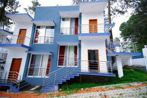 埃尔加德GV Resort的蓝色和白色的房子,前面有楼梯