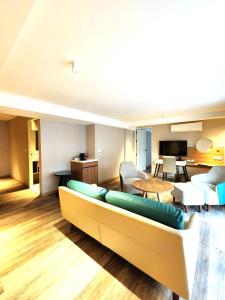芭东海滩Amalthea Hotel的客厅配有沙发和桌子