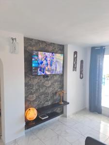 塔乌里托Vista taurito Ely的客厅的墙上配有电视
