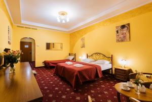 基辅Tiso Apart Hotel的酒店客房设有两张床和一张桌子。