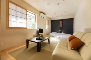 身延宿坊 志摩房 - Temple Hotel Simanobo的客厅配有沙发和桌子