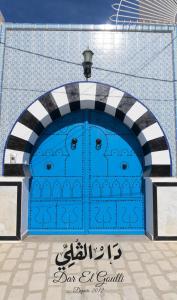 苏塞Dar El Goulli的蓝色车库门,前面有标志