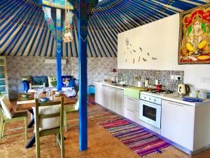 加藤德雷Exclusive Nirvana yurts Glamping的厨房配有带桌子和炉灶的帐篷