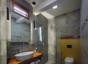 杰里科科拉Villa Nautica Boutique Hotel的一间带水槽和玻璃淋浴的浴室