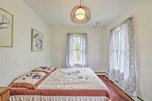维恩亚德海文Apt on Vineyard Haven Near Nantucket Sound!的一间卧室设有一张床和两个窗户。