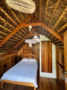 洛佩斯港Zutalu - Playa Sur的木天花板的客房内的一张床位