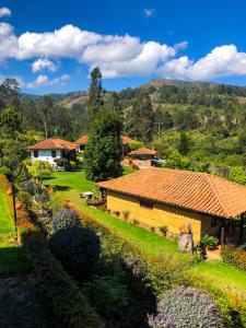 拉基拉Posada María del Carmen的一座有房子、树木和山脉的村庄