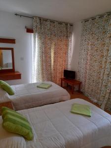 拉纳卡奥妮思罗斯酒店的一间卧室设有两张床、一台电视和一扇窗户。