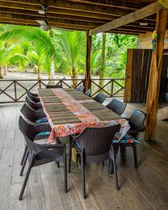 巴亚索拉诺playa mecana kirita的树木繁茂的甲板上的木桌和椅子