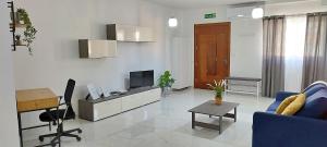 莫斯塔Stylish apartment in central Malta的客厅配有蓝色的沙发和电视