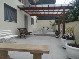 阿瓜斯-迪圣佩德罗A Pousadinha的庭院设有木制凉亭和桌椅