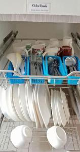 PataoDJL House Homestay -Bantayan Island的装满许多碗碟和餐具的冰箱