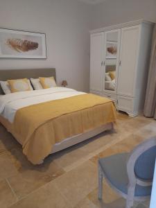 ŻabbarPalazzo Pisani Malta B&B的一间卧室配有一张带黄色毯子的大床