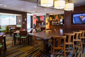 阿什兰Fairfield Inn & Suites by Marriott Richmond Ashland的一间带桌椅和电视的用餐室