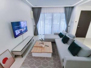莎阿南H+M Residence [5min]to Setia City Convention的客厅配有沙发和桌子