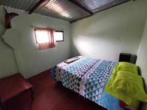 莫科阿Hostal de la montaña ecoturismo的一间卧室设有一张床和一个窗口