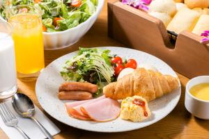 东京格拉斯丽新宿酒店的餐桌,带一盘食物,包括沙拉和面包