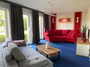 阔克威兹Ferienhaus LORINI的客厅配有两张沙发和一张红色沙发