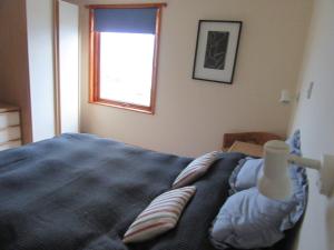 RosemarkieOsprey, Longhouse Cottages的一间卧室设有一张床和一个窗口