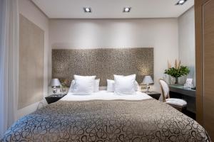 科尔多瓦Hospes Palacio del Bailio, a Member of Design Hotels的卧室配有带白色枕头的大床