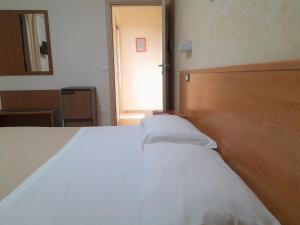 焦约萨马雷阿B&B Il Giardino di Zefiro的卧室配有白色的床和木制床头板