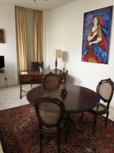 萨尔瓦多巴洛克巴伊亚酒店的客厅配有桌子和墙上的绘画