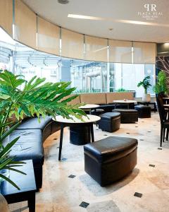 罗萨里奥广场里尔套房酒店的大堂设有桌椅和植物