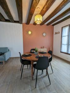 沙托鲁La Petite Chaume的一间带木桌和椅子的用餐室