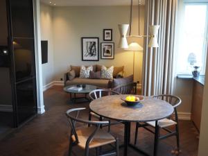 哥本哈根Hypernym Hotel & Suites的客厅配有桌椅和沙发