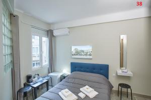 雅典ATHENS COMMERCIAL的一间卧室设有蓝色的床和窗户。
