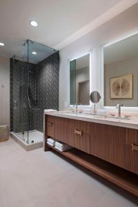 休斯顿The Westin Galleria Houston的一间带两个盥洗盆和淋浴的浴室