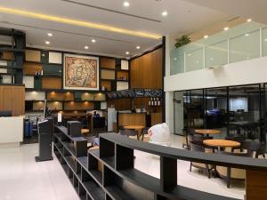 台北CHECK inn Taipei Neihu的一间带桌椅的餐厅和一间自助餐厅