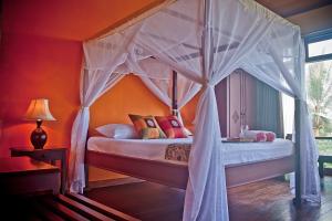 特尔纳特岛马雷塞别墅酒店的一间卧室配有一张带天蓬的床