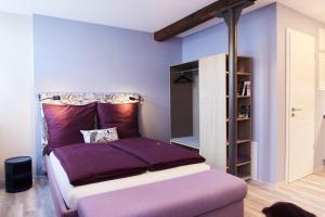 富尔达Fachwerk-Romantik am Dom的一间卧室配有一张紫色床单的床