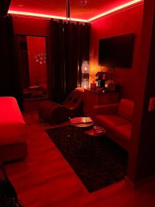 卢森堡LOVE ROOM - Luxembourg的红色的客厅配有沙发和电视