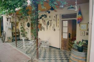 门多萨El Alero Hospedaje的一间设有桌椅和一棵树的房间
