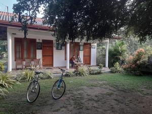波隆纳鲁沃River Nature Park的两辆自行车停在房子前面