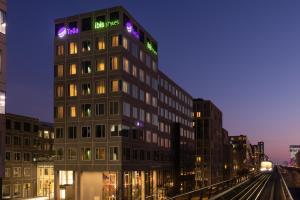 哥本哈根ibis Styles Copenhagen Orestad的一座高大的建筑,上面有标志