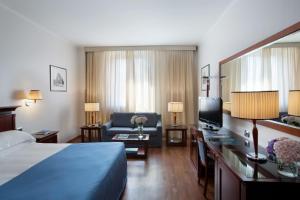 博洛尼亚星际埃克纱修酒店的酒店客房,配有床和沙发
