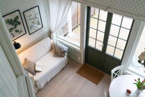 卢恩斯基尔Anfasteröd Gårdsvik - badstugor med loft的客厅配有白色沙发和2扇窗户。