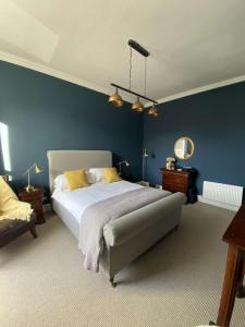 爱丁堡West End Townhouse的一间卧室配有一张带蓝色墙壁的大床