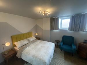 利物浦Urban Pod Hotel Liverpool的一间卧室配有一张床和一张蓝色椅子
