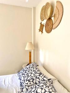 萨夸雷马Pousada OCEAN的卧室配有一张床,墙上挂着稻草帽